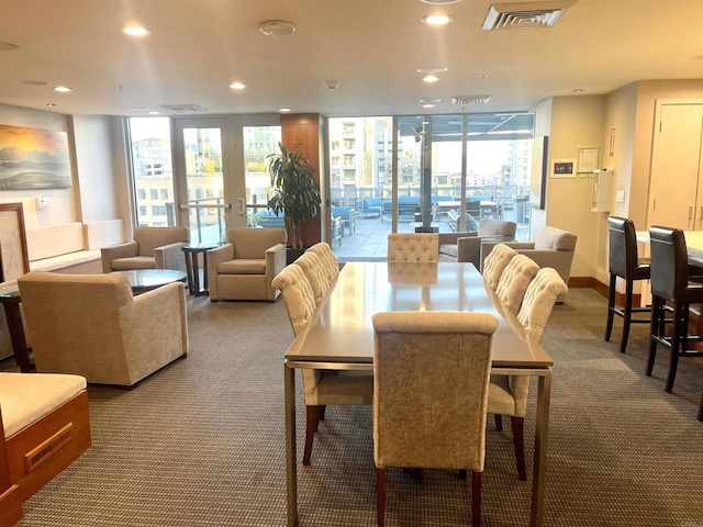 carpeted dining space featuring plenty of natural light and expansive windows