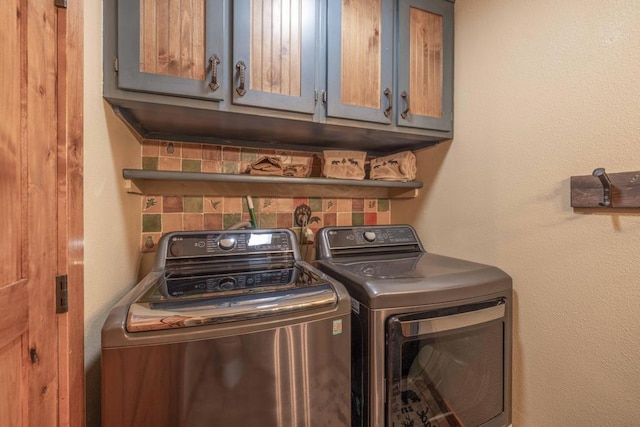 laundry room with cabinets and washer and clothes dryer