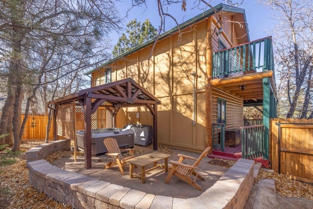 exterior space featuring a gazebo, a hot tub, and area for grilling