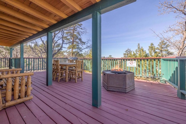 wooden terrace with a fire pit