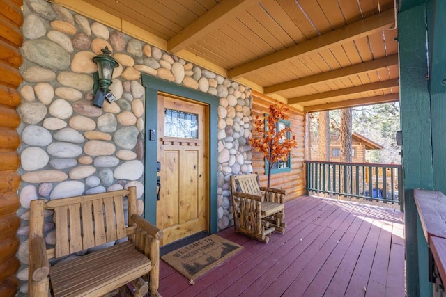 wooden terrace featuring covered porch