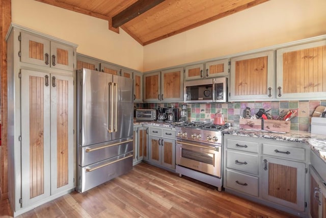 kitchen with wooden ceiling, backsplash, vaulted ceiling with beams, high end appliances, and light stone counters