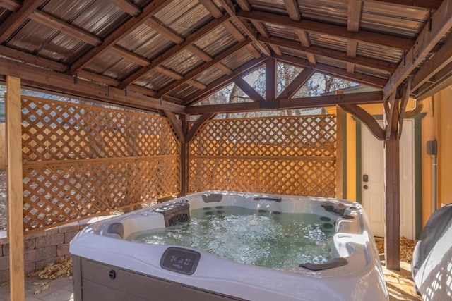 wooden terrace with a gazebo and a hot tub