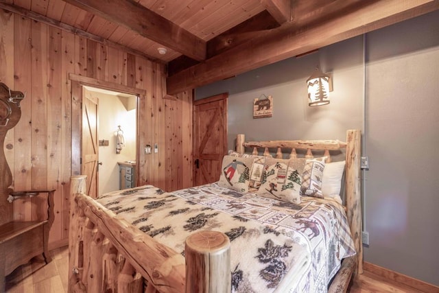 bedroom featuring wooden ceiling, wood walls, beamed ceiling, and light wood-type flooring