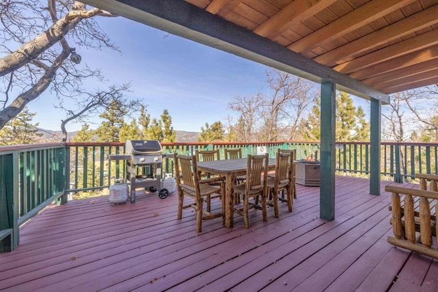 wooden deck featuring a grill