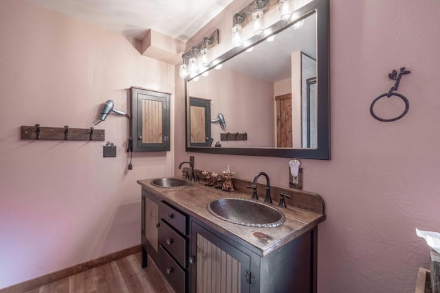 bathroom with hardwood / wood-style flooring and vanity