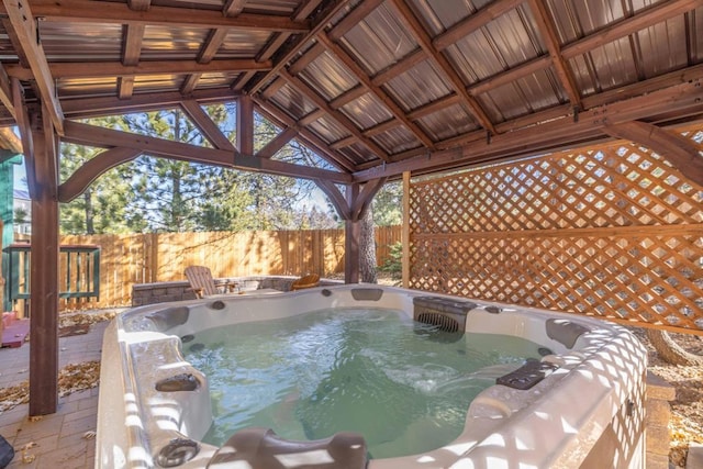 view of pool with a gazebo and a hot tub