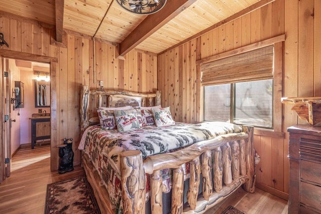 bedroom with beam ceiling, wood-type flooring, wood ceiling, and wood walls