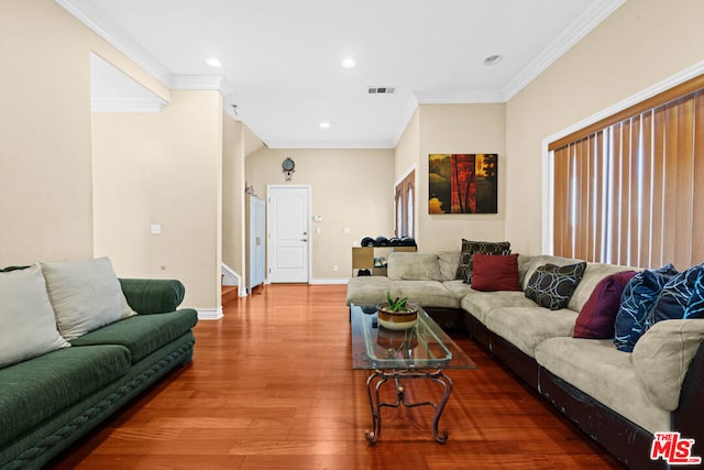 living room featuring wood-type flooring and ornamental molding