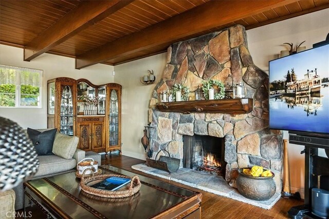 living room featuring a fireplace, hardwood / wood-style floors, beam ceiling, and wood ceiling