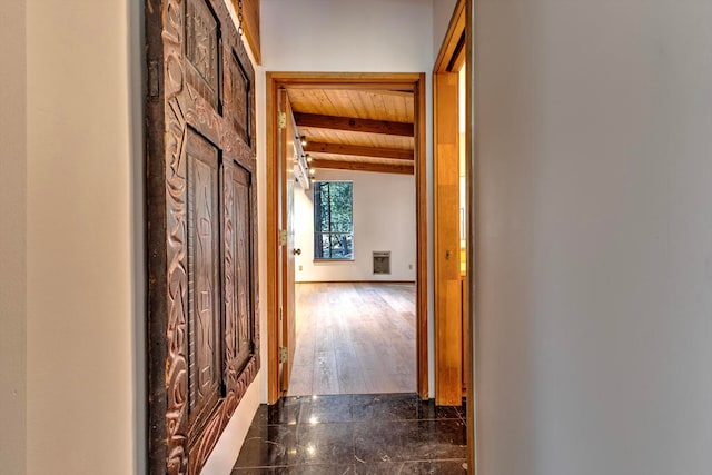 hall with vaulted ceiling with beams, dark wood-type flooring, and wooden ceiling