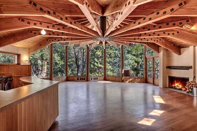 interior space with vaulted ceiling with beams, a wealth of natural light, and wood ceiling