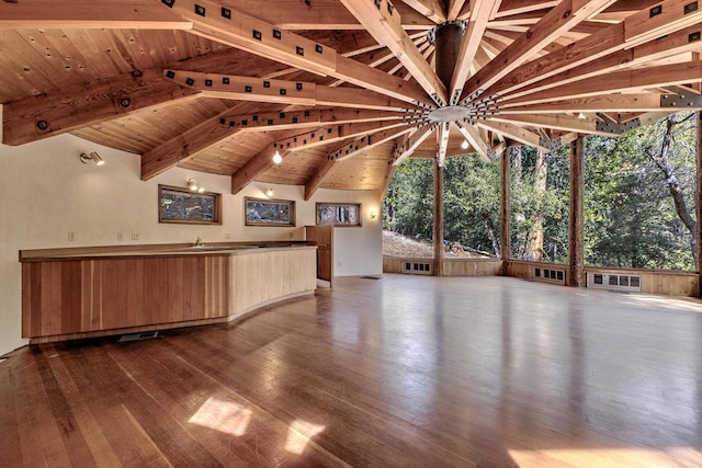 interior space with wood-type flooring, wooden ceiling, and a healthy amount of sunlight