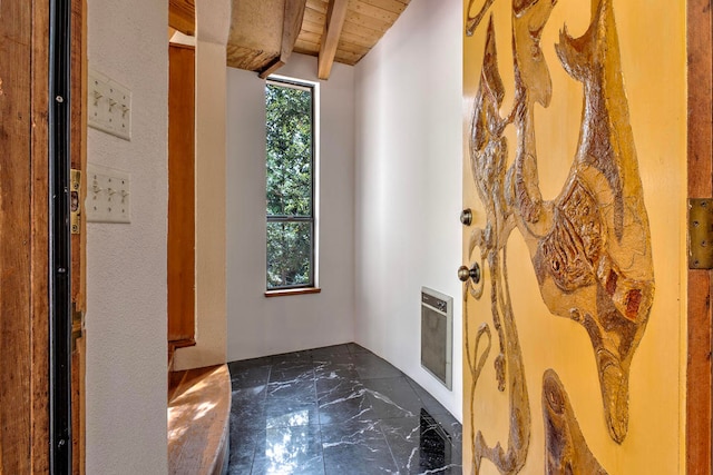 doorway featuring beam ceiling, heating unit, and wooden ceiling