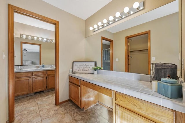 bathroom featuring ceiling fan and vanity