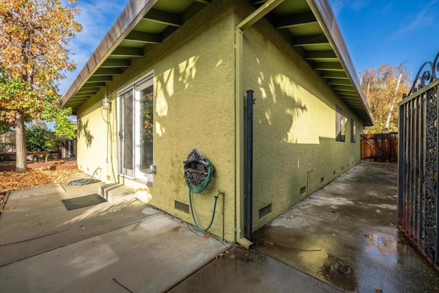 view of side of property with a patio