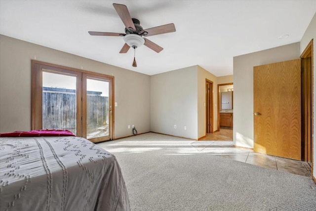 bedroom with ceiling fan, light colored carpet, access to outside, and ensuite bath