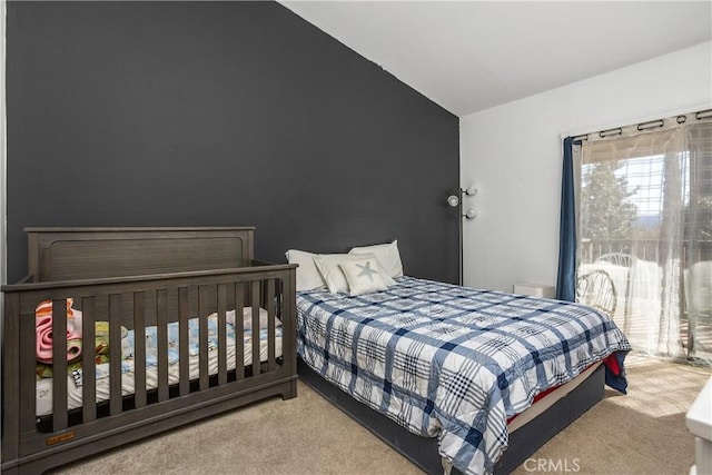 carpeted bedroom featuring vaulted ceiling