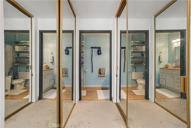 bathroom featuring vanity, hardwood / wood-style flooring, and toilet