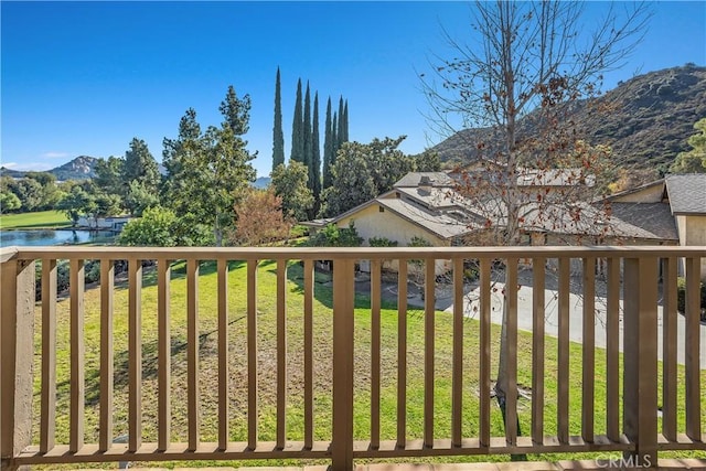 exterior space with a yard and a water and mountain view