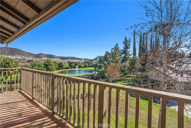 balcony with a water and mountain view