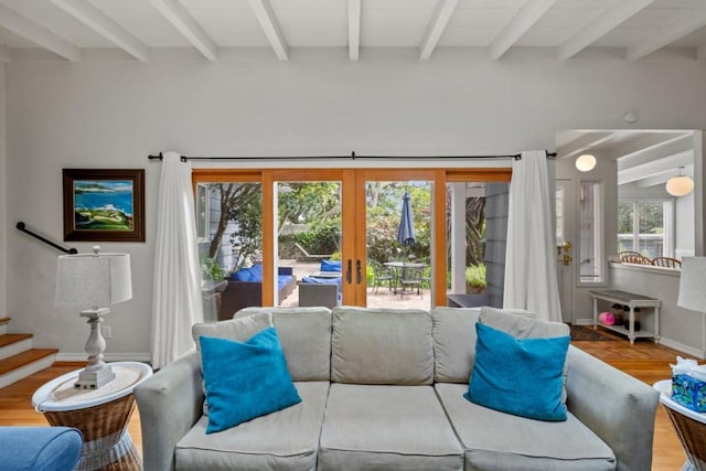 living room featuring french doors, beam ceiling, and hardwood / wood-style floors