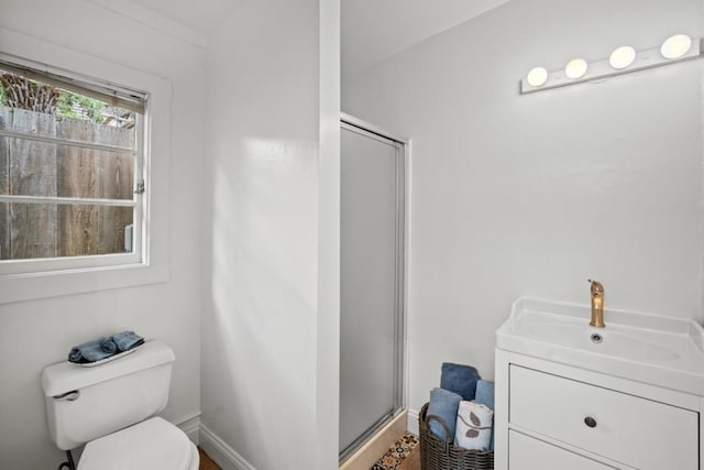 bathroom featuring vanity, toilet, and walk in shower