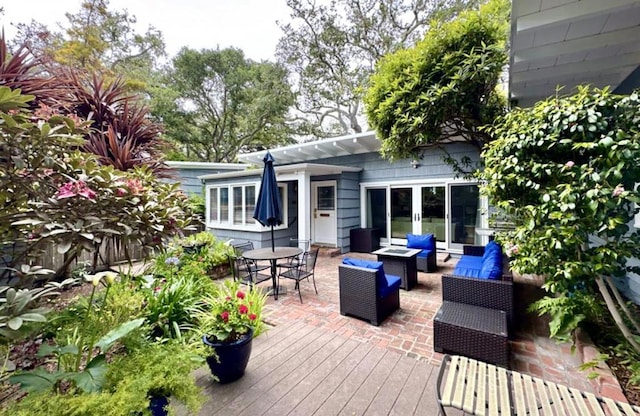 wooden terrace featuring french doors and an outdoor hangout area