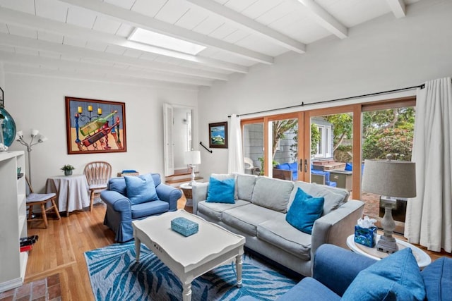 living room with wood-type flooring, french doors, and beam ceiling