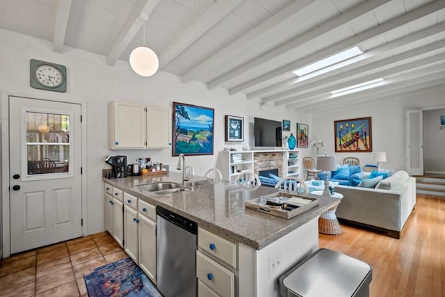 kitchen with sink, beam ceiling, dishwasher, light hardwood / wood-style floors, and hanging light fixtures