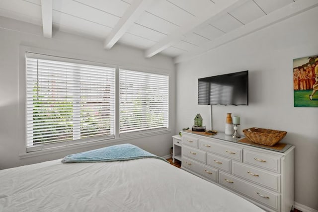 bedroom featuring vaulted ceiling with beams