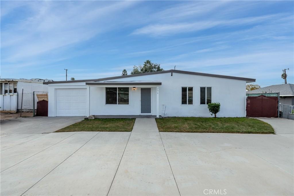 single story home with a front lawn and a garage