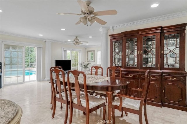 dining room with decorative columns, a wealth of natural light, crown molding, and ceiling fan