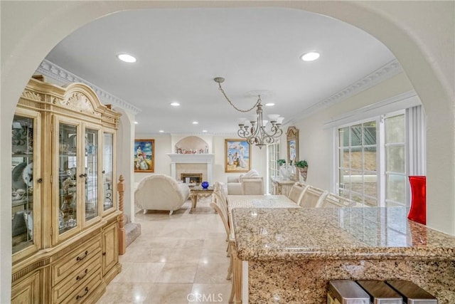 dining space featuring ornamental molding and a chandelier