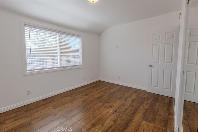 empty room with dark hardwood / wood-style flooring