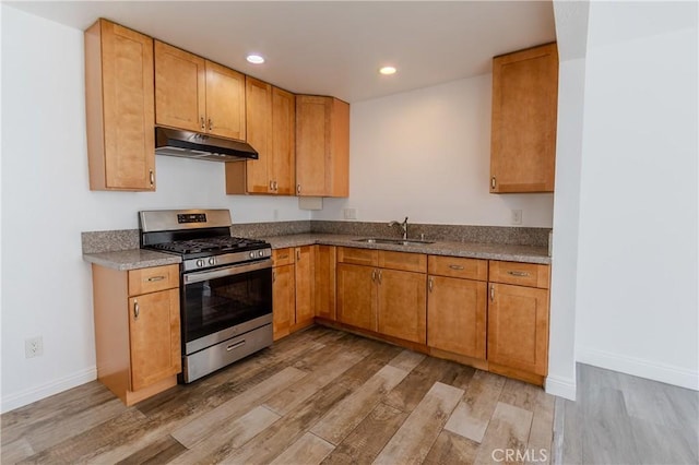 kitchen featuring light hardwood / wood-style floors, sink, and stainless steel range with gas stovetop