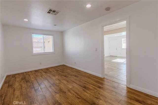 unfurnished room with wood-type flooring