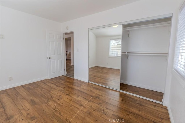 unfurnished bedroom with hardwood / wood-style floors and a closet