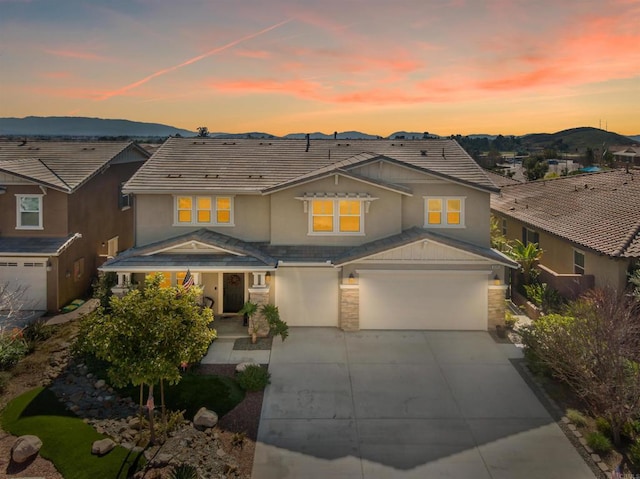 view of front of home featuring a garage and a mountain view