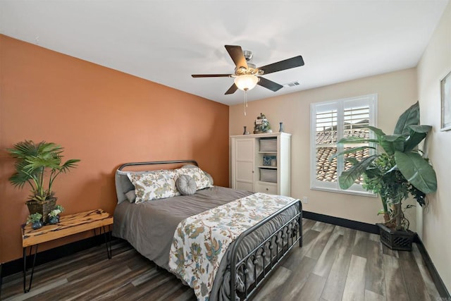 bedroom with ceiling fan and dark hardwood / wood-style floors