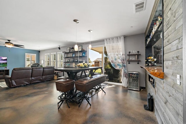 dining room with beverage cooler and ceiling fan