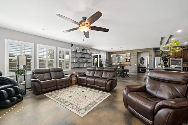 living room with ceiling fan and sink