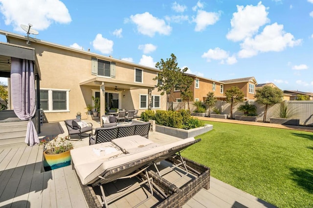 rear view of property featuring a deck and a lawn