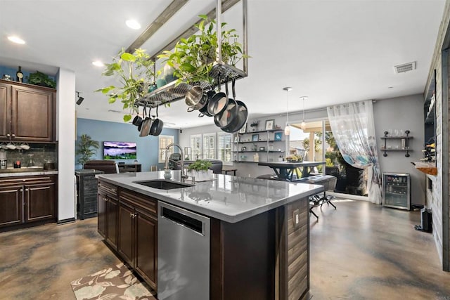 kitchen with dark brown cabinets, dishwasher, an island with sink, sink, and wine cooler