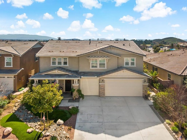 30343 Mahogany St, Murrieta, CA 92563 - view of front of house featuring stucco siding, a tiled roof, a garage, stone siding, and concrete driveway