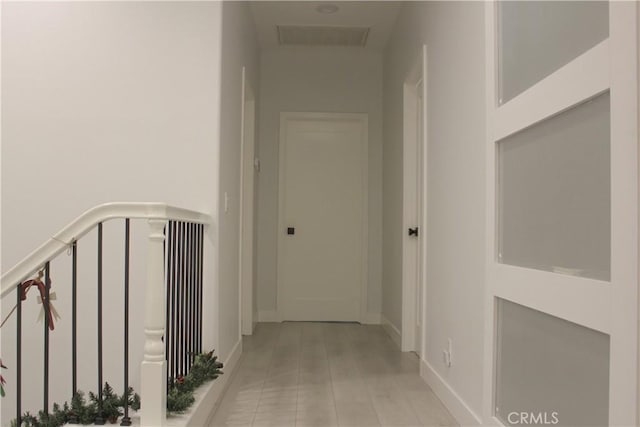 hallway with light tile patterned flooring