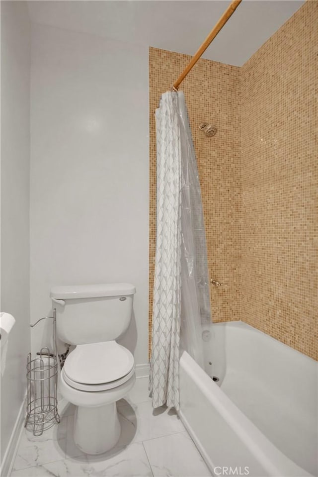 bathroom with shower / bath combination with curtain and toilet