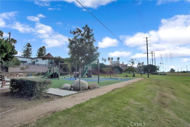 surrounding community featuring a playground and a lawn