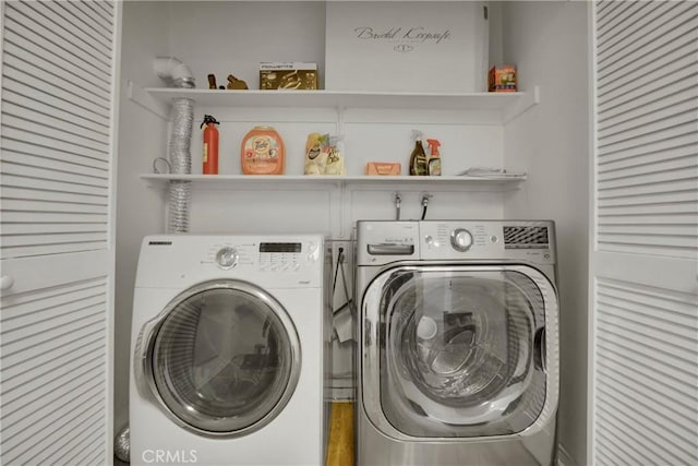 clothes washing area with separate washer and dryer