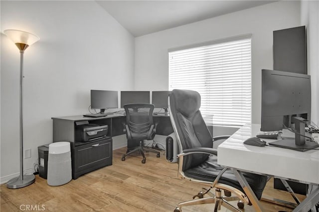 office space with lofted ceiling and light hardwood / wood-style floors